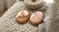 Somatic Anchors — two solid copper weights by kalarthe., resting on natural textile